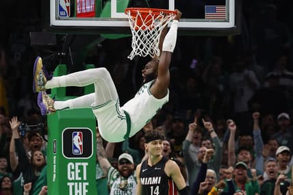 Oct 27, 2023; Boston, Massachusetts, USA; Boston Celtics guard Jaylen Brown (7) shouts out after dunking over Miami Heat guard Tyler Herro (14) during the second quarter at TD Garden. Mandatory Credit: Winslow Townson-USA TODAY Sports