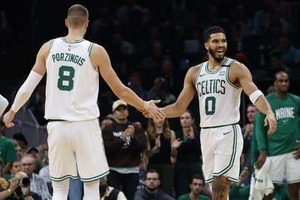 Oct 27, 2023; Boston, Massachusetts, USA; Boston Celtics forward Jayson Tatum (0) slaps hands with center Kristaps Porzingis (8) during the second quarter against the Miami Heat at TD Garden. Mandatory Credit: Winslow Townson-USA TODAY Sports