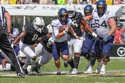 Oct 28, 2023; Orlando, Florida, USA; West Virginia Mountaineers quarterback Garrett Greene (6) carries the ball during the second quarter against the UCF Knights at FBC Mortgage Stadium. Mandatory Credit: Mike Watters-USA TODAY Sports