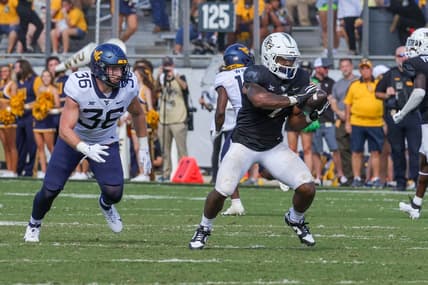 Oct 28, 2023; Orlando, Florida, USA; UCF Knights running back RJ Harvey (7) catches a pass in front of West Virginia Mountaineers linebacker Caden Biser (36) during the second half at FBC Mortgage Stadium. Mandatory Credit: Mike Watters-USA TODAY Sports