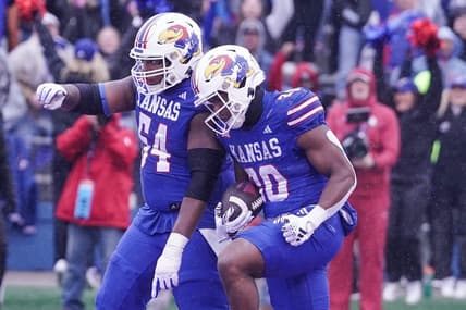 Oct 28, 2023; Lawrence, Kansas, USA; Kansas Jayhawks running back Daniel Hishaw Jr. (20) celebrates with offensive lineman Michael Ford Jr. (54) after scoring against the Oklahoma Sooners during the first half at David Booth Kansas Memorial Stadium. Mandatory Credit: Denny Medley-USA TODAY Sports