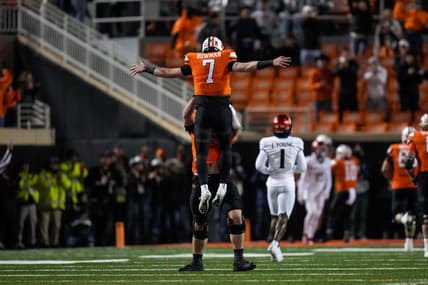 Oklahoma State Cowboys quarterback Alan Bowman (7) and offensive lineman Dalton Cooper (71) celebrate a touchdown pass in the first quarter of the NCAA Big12 football game between the Oklahoma State Cowboys and the Cincinnati Bearcats at Boone Pickens Stadium in Stillwater, Okla., on Saturday, Oct. 28, 2023.
