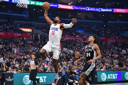 Oct 29, 2023; Los Angeles, California, USA; Los Angeles Clippers forward Paul George (13) scores a basket ahead of San Antonio Spurs guard Devin Vassell (24) during the first half at Crypto.com Arena. Mandatory Credit: Gary A. Vasquez-USA TODAY Sports