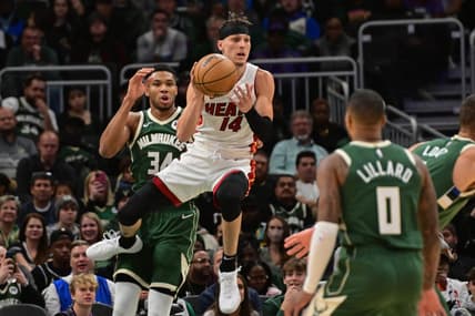 Oct 30, 2023; Milwaukee, Wisconsin, USA;  Miami Heat guard Tyler Herro (14) grabs a rebound against Milwaukee Bucks forward Giannis Antetokounmpo (34) in the first quarter at Fiserv Forum. Mandatory Credit: Benny Sieu-USA TODAY Sports
