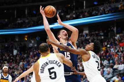 Oct 30, 2023; Denver, Colorado, USA; Utah Jazz guard Collin Sexton (2) fouls Denver Nuggets center Nikola Jokic (15) in the second half at Ball Arena. Mandatory Credit: Ron Chenoy-USA TODAY Sports