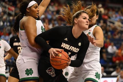 Mar 3, 2023; Greensboro, NC, USA; NC State Wolfpack center River Baldwin (1) controls the ball against Notre Dame Fighting Irish center Lauren Ebo (33) and forward Maddy Westbeld (21) during the first half at Greensboro Coliseum. Mandatory Credit: William Howard-USA TODAY Sports