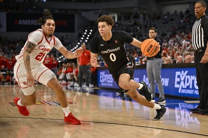 Mar 11, 2023; Fort Worth, TX, USA; Cincinnati Bearcats guard Dan Skillings Jr. (0) drives to the basket against Houston Cougars guard Emanuel Sharp (21) during the second half at Dickies Arena. Mandatory Credit: Jerome Miron-USA TODAY Sports