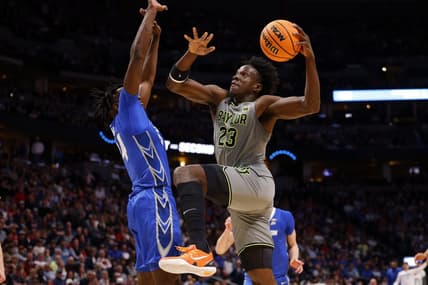 Mar 19, 2023; Denver, CO, USA; Baylor Bears forward Jonathan Tchamwa Tchatchoua (23) shoots against Creighton Bluejays forward Arthur Kaluma (24) in the second half at Ball Arena. Mandatory Credit: Michael Ciaglo-USA TODAY Sports