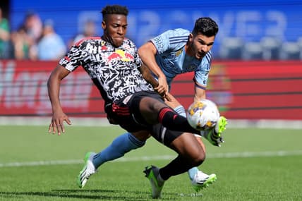 Sep 16, 2023; New York, New York, USA; New York Red Bulls defender Hassan Ndam (98) plays the ball against New York City FC forward Mounsef Bakrar (9) during the first half at Yankee Stadium. Mandatory Credit: Brad Penner-USA TODAY Sports