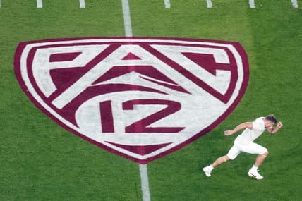 Oct 21, 2023; Stanford, California, USA; A view of the Pac-12 logo on the field as Stanford Cardinal wide receiver David Kasemervisz (80) warms up before the game against the UCLA Bruins at Stanford Stadium. Mandatory Credit: Darren Yamashita-USA TODAY Sports