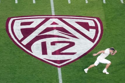 Oct 21, 2023; Stanford, California, USA; A view of the Pac-12 logo on the field as Stanford Cardinal wide receiver David Kasemervisz (80) warms up before the game against the UCLA Bruins at Stanford Stadium. Mandatory Credit: Darren Yamashita-USA TODAY Sports