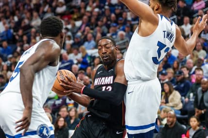 Oct 28, 2023; Minneapolis, Minnesota, USA; Miami Heat center Bam Adebayo (13) drives to the basket as Minnesota Timberwolves center Karl-Anthony Towns (32) and guard Anthony Edwards (5) defend in the second quarter at Target Center. Mandatory Credit: Matt Blewett-USA TODAY Sports