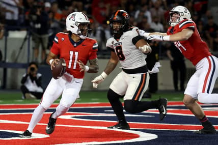 Oct 28, 2023; Tucson, Arizona, USA; Arizona Wildcats quarterback Noah Fifita #11 drops back to make a pass against Oregon State Beavers defensive lineman Sione Lolohea #8 during the first half at Arizona Stadium. Mandatory Credit: Zachary BonDurant-USA TODAY Sports