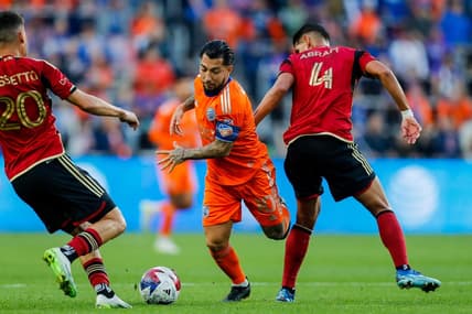 Oct 21, 2023; Cincinnati, Ohio, USA; FC Cincinnati midfielder Luciano Acosta (10) battles for the ball against Atlanta United FC midfielder Matheus Rossetto (20) and defender Luis Abram (4) in the first half at TQL Stadium. Mandatory Credit: Katie Stratman-USA TODAY Sports