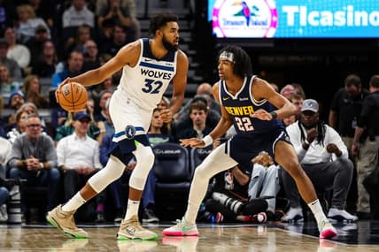 Nov 1, 2023; Minneapolis, Minnesota, USA; Minnesota Timberwolves center Karl-Anthony Towns (32) dribbles while Denver Nuggets forward Zeke Nnaji (22) defends during the first half at Target Center. Mandatory Credit: Matt Krohn-USA TODAY Sports