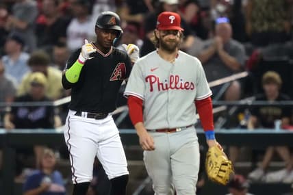 Arizona Diamondbacks shortstop Geraldo Perdomo (left) reacts after hitting a single during the seventh inning as Philadelphia Phillies first baseman Bryce Harper (right) looks on in game four of the NLCS of the 2023 MLB playoffs at Chase Field in Phoenix on Oct. 20, 2023.