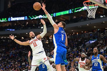 Nov 3, 2023; Milwaukee, Wisconsin, USA; New York Knicks guard Jalen Brunson (11) takes a shot against Milwaukee Bucks center Brook Lopez (11) in the fourth quarter at Fiserv Forum. Mandatory Credit: Benny Sieu-USA TODAY Sports