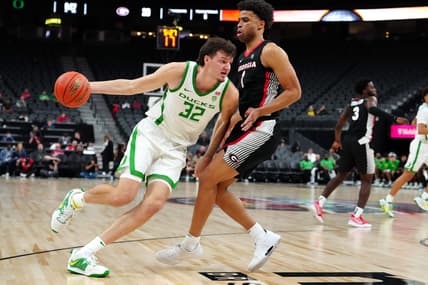 Nov 6, 2023; Las Vegas, Nevada, USA; Oregon Ducks center Nate Bittle (32) dribbles against Georgia Bulldogs guard Jabri Abdur-Rahim (1) during the first half at T-Mobile Arena. Mandatory Credit: Stephen R. Sylvanie-USA TODAY Sports