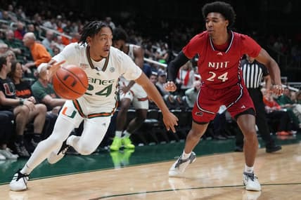Nov 6, 2023; Coral Gables, Florida, USA; Miami (Fl) Hurricanes guard Nijel Pack (24) drives past N.J.I.T Highlanders guard Mekhi Gray (24) in the first half at Watsco Center. Mandatory Credit: Jim Rassol-USA TODAY Sports