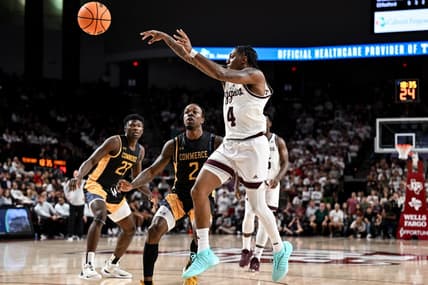 Nov 6, 2023; College Station, Texas, USA; Texas A&M Aggies guard Wade Taylor IV (4) passes the ball as Texas A&M Commerce guard Kalen Williams (2) defends during the second half at Reed Arena. Mandatory Credit: Maria Lysaker-USA TODAY Sports