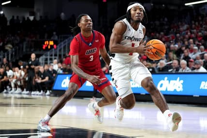 Cincinnati Bearcats guard Day Day Thomas (1) drives to the basket as Illinois-Chicago Flames guard CJ Jones (3) defends in the first half of a men   s college basketball game between the Illinois-Chicago Flames and the Cincinnati Bearcats, Monday, Nov. 6, 2023, at Fifth Third Arena in Cincinnati.
