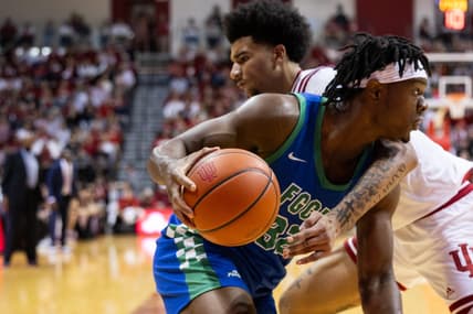 Nov 7, 2023; Bloomington, Indiana, USA; Florida Gulf Coast Eagles forward Keeshawn Kellman (32) dribbles against Indiana Hoosiers center Kel'el Ware (1) in the second half at Simon Skjodt Assembly Hall. Mandatory Credit: Trevor Ruszkowski-USA TODAY Sports