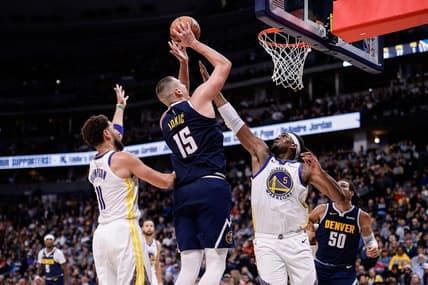 Nov 8, 2023; Denver, Colorado, USA; Denver Nuggets center Nikola Jokic (15) attempts a shot against Golden State Warriors forward Kevon Looney (5) and guard Klay Thompson (11) in the third quarter at Ball Arena. Mandatory Credit: Isaiah J. Downing-USA TODAY Sports