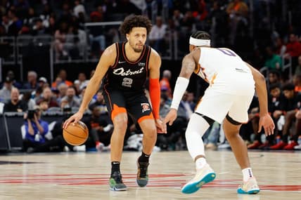 Nov 5, 2023; Detroit, Michigan, USA;  Detroit Pistons guard Cade Cunningham (2) dribbles defended by Phoenix Suns guard Jordan Goodwin (0) at Little Caesars Arena. Mandatory Credit: Rick Osentoski-USA TODAY Sports