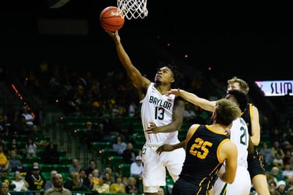 Nov 9, 2023; Waco, Texas, USA;  Baylor Bears guard Langston Love (13) scores a basket against John Brown Golden Eagles forward Lukas Gabani (25) during the second half at Ferrell Center. Mandatory Credit: Chris Jones-USA TODAY Sports