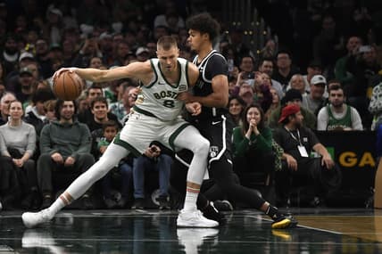 Nov 10, 2023; Boston, Massachusetts, USA;  Boston Celtics center Kristaps Porzingis (8) controls the ball while Brooklyn Nets forward Cameron Johnson (2) defends during the first half at TD Garden. Mandatory Credit: Bob DeChiara-USA TODAY Sports
