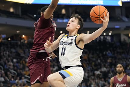 Nov 10, 2023; Milwaukee, Wisconsin, USA;  Marquette Golden Eagles guard Tyler Kolek (11) shoots against Rider Broncs forward Tariq Ingraham (33) during the first half at Fiserv Forum. Mandatory Credit: Jeff Hanisch-USA TODAY Sports