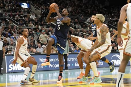 Nov 10, 2023; San Antonio, Texas, USA; Minnesota Timberwolves guard Anthony Edwards (5) drives to the basket between San Antonio Spurs forward Jeremy Sochan (10) and guard Tre Jones (33) during the second half at Frost Bank Center. Mandatory Credit: Scott Wachter-USA TODAY Sports