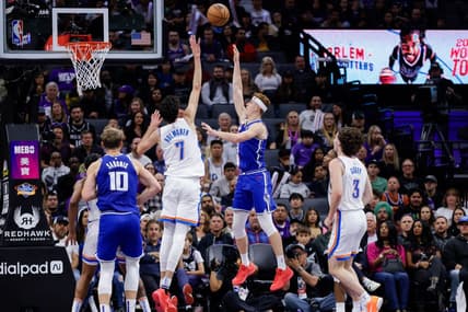 Nov 10, 2023; Sacramento, California, USA; Sacramento Kings guard Kevin Huerter (9) shoots the ball over Oklahoma City Thunder forward Chet Holmgren (7) during the second quarter at Golden 1 Center. Mandatory Credit: Sergio Estrada-USA TODAY Sports