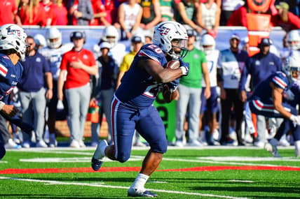 Nov 11, 2023; Lynchburg, Virginia, USA;  Liberty Flames running back Quinton Cooley (20) runs the ball in the third quarter at Williams Stadium. Mandatory Credit: Brian Bishop-USA TODAY Sports