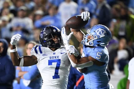 Nov 11, 2023; Chapel Hill, North Carolina, USA; North Carolina Tar Heels wide receiver J.J. Jones (5) catches the ball as Duke Blue Devils cornerback Al Blades Jr. (7) defends in the second quarter at Kenan Memorial Stadium. Mandatory Credit: Bob Donnan-USA TODAY Sports