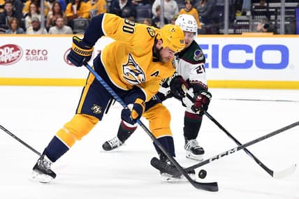 Nov 11, 2023; Nashville, Tennessee, USA; Nashville Predators center Ryan O'Reilly (90) handles the puck during the first period against the Arizona Coyotes at Bridgestone Arena. Mandatory Credit: Christopher Hanewinckel-USA TODAY Sports