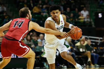 Nov 12, 2023; Waco, Texas, USA;  Baylor Bears guard RayJ Dennis (10) controls the ball against Gardner Webb Runnin Bulldogs guard Shahar Lazar (14) during the first half at Ferrell Center. Mandatory Credit: Chris Jones-USA TODAY Sports