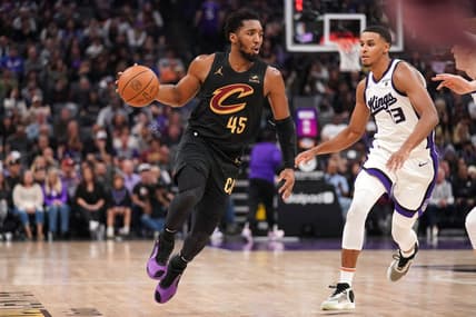 Nov 13, 2023; Sacramento, California, USA; Cleveland Cavaliers guard Donovan Mitchell (45) dribbles the ball next to Sacramento Kings forward Keegan Murray (13) in the second quarter at the Golden 1 Center. Mandatory Credit: Cary Edmondson-USA TODAY Sports