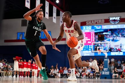 Nov 14, 2023; Boca Raton, Florida, USA; Florida Atlantic Owls guard Johnell Davis (1) dribbles the ball past Eastern Michigan Eagles forward Jalin Billingsley (1) during the first half at Eleanor R. Baldwin Arena. Mandatory Credit: Rich Storry-USA TODAY Sports