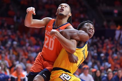 Nov 14, 2023; Champaign, Illinois, USA; Illinois Fighting Illini forward Ty Rodgers (20) and Marquette Golden Eagles guard Kam Jones (1) battle for position during the first half at State Farm Center. Mandatory Credit: Ron Johnson-USA TODAY Sports