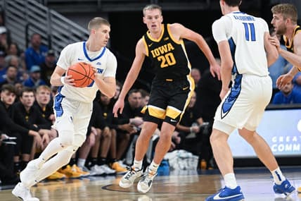 Nov 14, 2023; Omaha, Nebraska, USA; Creighton Bluejays guard Baylor Scheierman (55) drives against Iowa Hawkeyes forward Payton Sandfort (20) in the first half at CHI Health Center Omaha. Mandatory Credit: Steven Branscombe-USA TODAY Sports