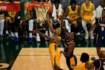 Nov 14, 2023; Waco, Texas, USA; Baylor Bears guard Jayden Nunn (2) scores a layup past UMKC Kangaroos guard Jayson Petty (1) during the second half at Ferrell Center. Mandatory Credit: Chris Jones-USA TODAY Sports
