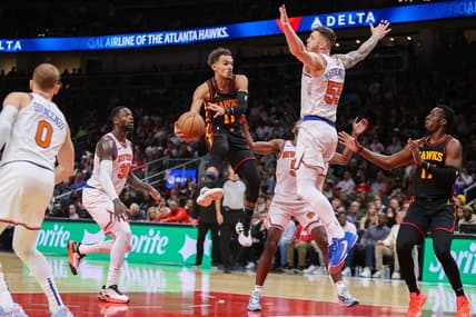 Nov 15, 2023; Atlanta, Georgia, USA; Atlanta Hawks guard Trae Young (11) passes around New York Knicks center Isaiah Hartenstein (55) in the second half at State Farm Arena. Mandatory Credit: Brett Davis-USA TODAY Sports