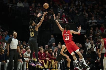 Nov 15, 2023; Portland, Oregon, USA; Cleveland Cavaliers guard Donovan Mitchell (45) shoots a basket during the first half against Portland Trail Blazers forward Toumani Camara (33) at Moda Center. Mandatory Credit: Troy Wayrynen-USA TODAY Sports
