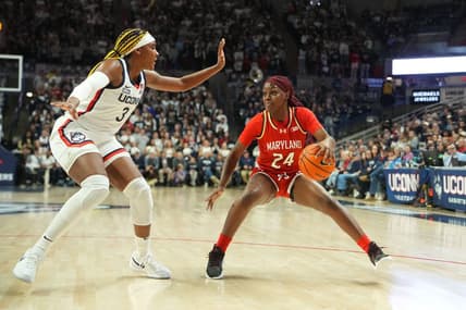 Nov 16, 2023; Storrs, Connecticut, USA; Maryland Terrapins guard Bri McDaniel (24) dribbles the ball against Connecticut Huskies forward Aaliyah Edwards (3) during the first half at Harry A. Gampel Pavilion. Mandatory Credit: Gregory Fisher-USA TODAY Sports