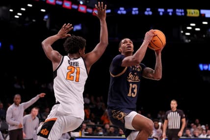 Nov 17, 2023; Brookyln, NY, USA; Notre Dame Fighting Irish forward Tae Davis (13) looks to shoot the ball against Oklahoma State Cowboys forward Justin McBride (21) during the first half at Barclays Center. Mandatory Credit: Brad Penner-USA TODAY Sports