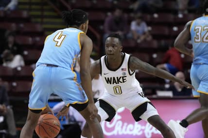 Nov 17, 2023; Charleston, SC, USA; Wake Forest Demon Deacons guard Kevin Miller (0) defends against Towson Tigers guard Dylan Williamson (4) in the second half at TD Arena. Mandatory Credit: David Yeazell-USA TODAY Sports