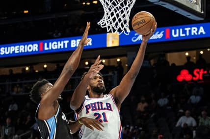 Nov 17, 2023; Atlanta, Georgia, USA; Philadelphia 76ers center Joel Embiid (21) shoots layup against Atlanta Hawks center Clint Capela (15) during the first quarter at State Farm Arena. Mandatory Credit: Jordan Godfree-USA TODAY Sports