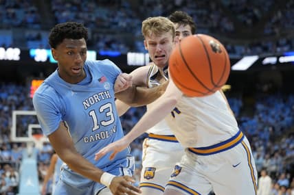 Nov 17, 2023; Chapel Hill, North Carolina, USA; North Carolina Tar Heels forward Jalen Washington (13) and UC Riverside Highlanders forward Wil Tattersall (14) fight for the ball in the first half at Dean E. Smith Center. Mandatory Credit: Bob Donnan-USA TODAY Sports