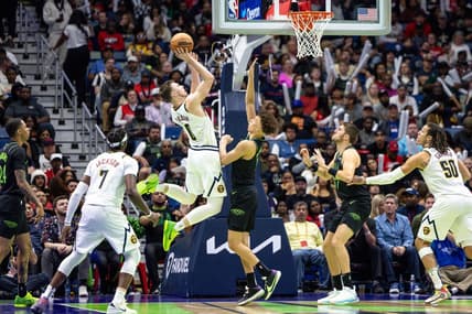 Nov 17, 2023; New Orleans, Louisiana, USA;  Denver Nuggets guard Christian Braun (0) shoots a jump shot against New Orleans Pelicans guard Dyson Daniels (11) during the second half at the Smoothie King Center. Mandatory Credit: Stephen Lew-USA TODAY Sports